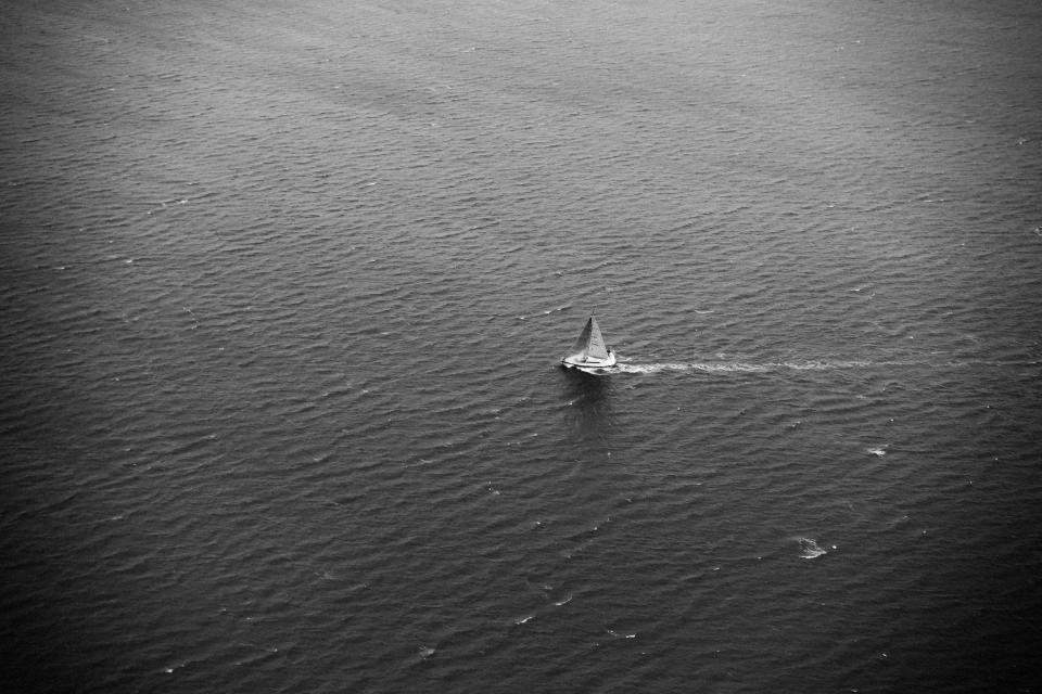 A lone sailboat at sea
